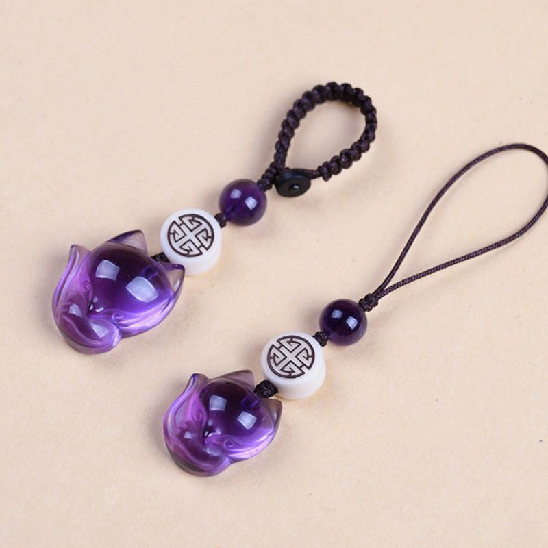 Quartz Fox Keychain – two deep purple crystal fox head charms with white pattern beads on cream surface, crystal keychain