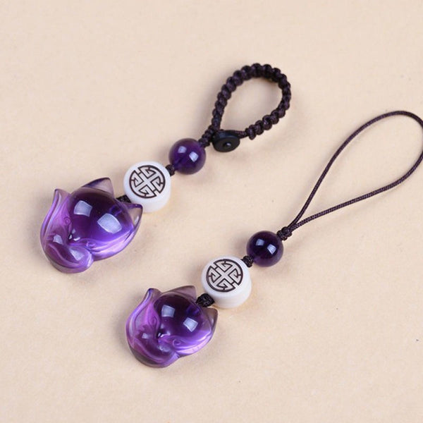 Quartz Fox Keychain – two deep purple crystal fox head charms with white pattern beads on cream surface, crystal keychain