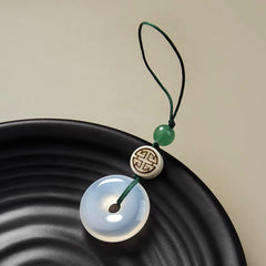 Chalcedony Peace Disc Keychain – translucent jade bi disc with green cord and symbol bead