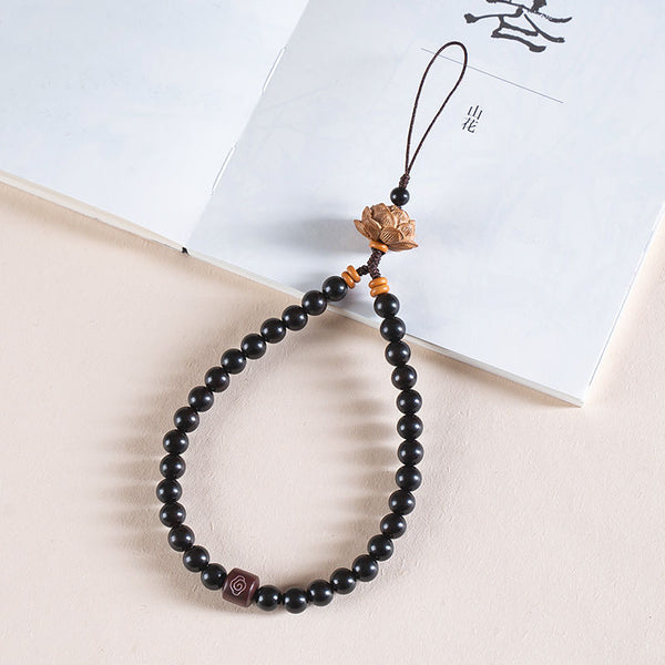 Zodiac Wood Bead Lanyard – Black ebony wood bead phone strap with lotus finial on white journal, protective zodiac lanyard