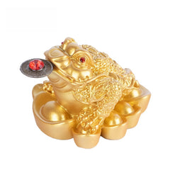 Golden Money Toad – three-legged frog with red gem eyes holding lucky coin on gold ingots, feng shui wealth