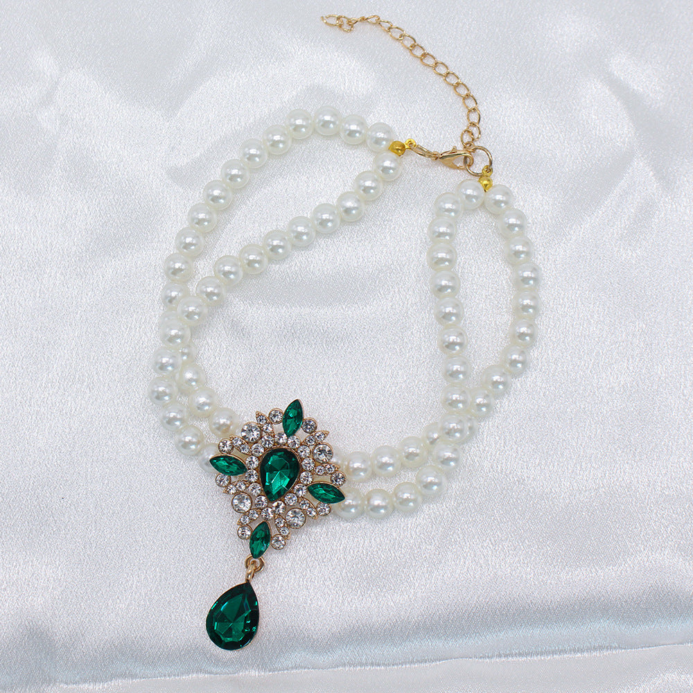 Elegant Pearl Crystal Collar – Double-layer pearl collar with green teardrop crystal pendant, white satin