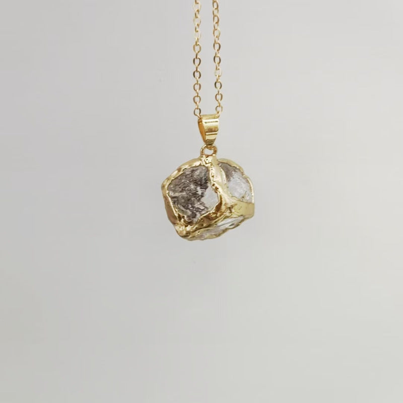 Gemstone Chip Pendant – Clear quartz raw crystal cube in gold rim on chain, gray background, healing necklace