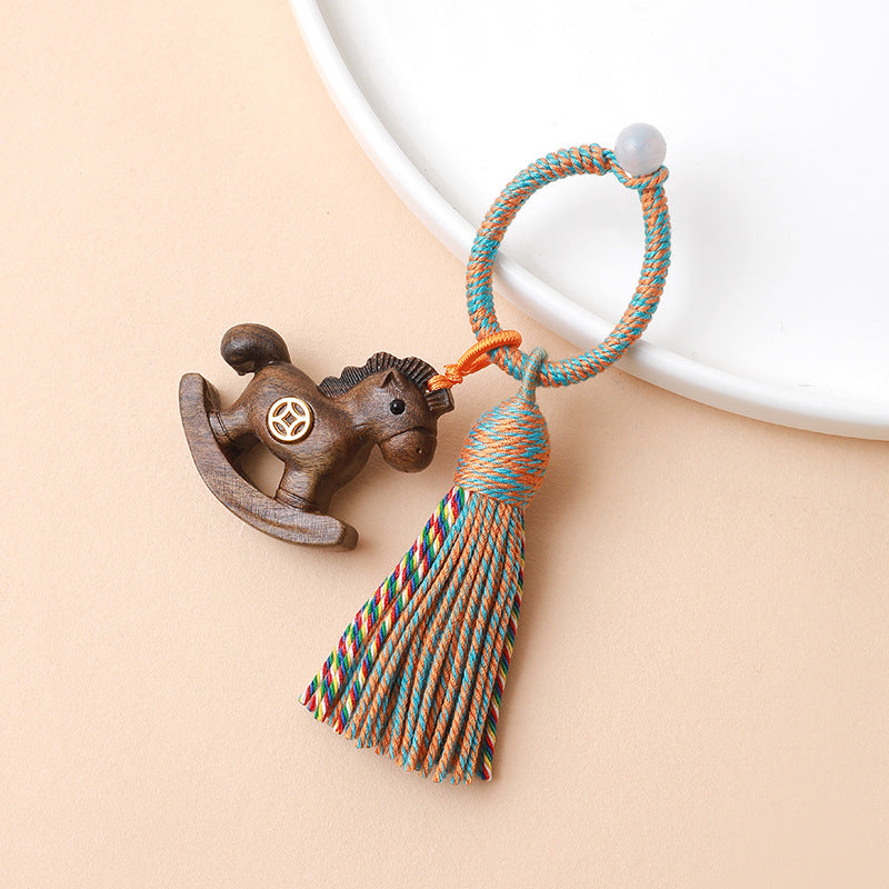 Rainbow Wooden Horse Keychain – dark brown wooden rocking horse with colorful braided tassel
