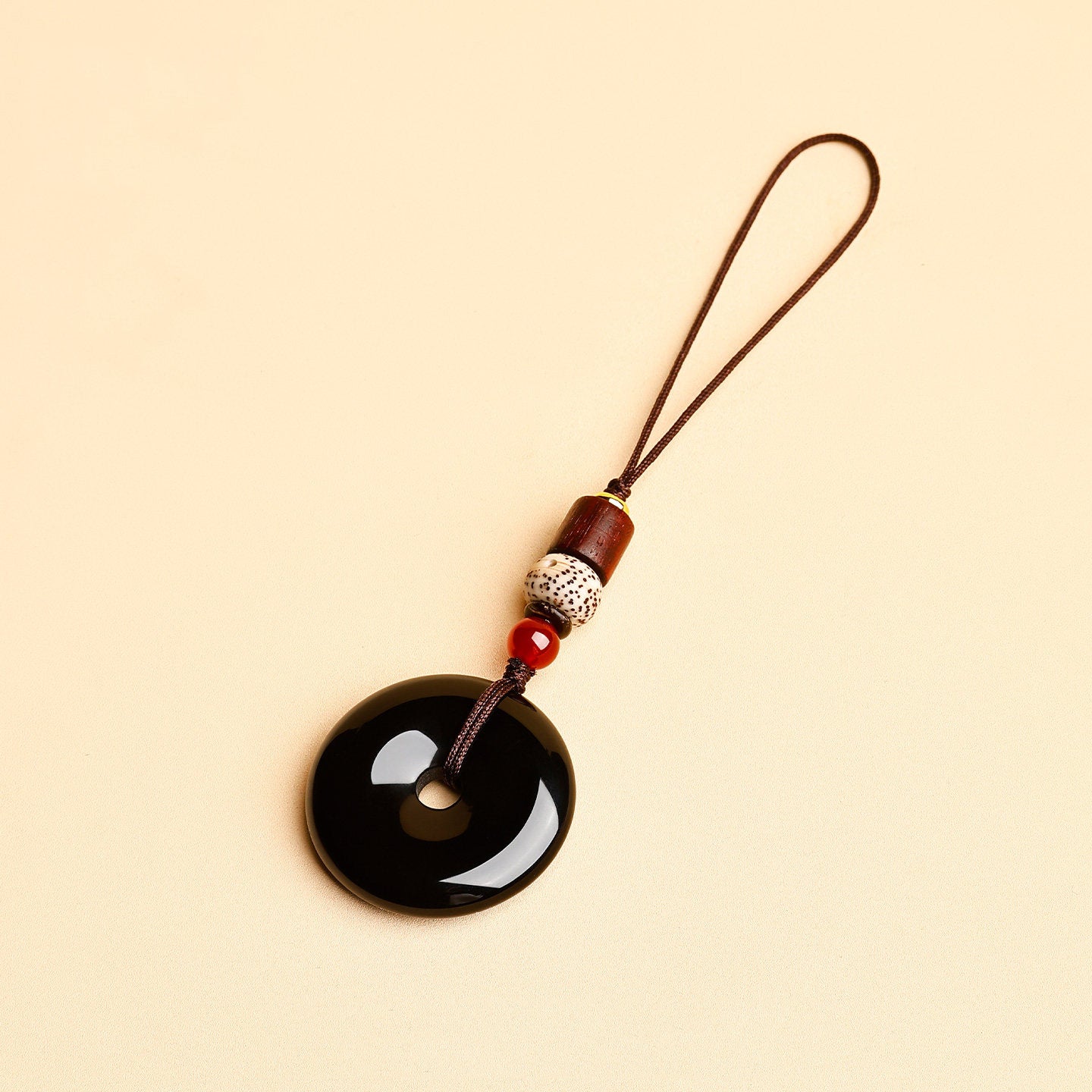 Jade Keychain Pendant – Black jade donut with slim cord and star moon bodhi beads on beige, minimalist keychain