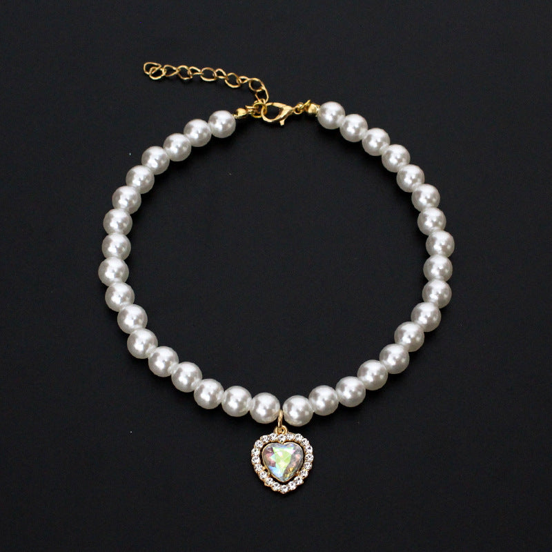 Crystal Heart Pet Necklace – Pearl collar with iridescent heart crystal pendant surrounded by rhinestones