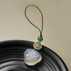 Chalcedony Ruyi Keychain – white chalcedony ruyi cloud pendant with green bead on black dish