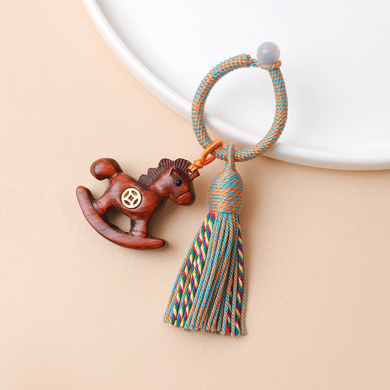 Rainbow Wooden Horse Keychain – reddish-brown wooden horse charm with colorful tassel and rope