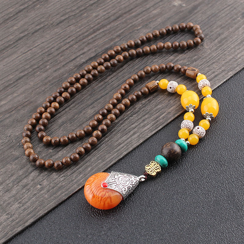 Wenge Mala Necklace – 108 beads with orange carved pendant in silver cap yellow white beads, wood background