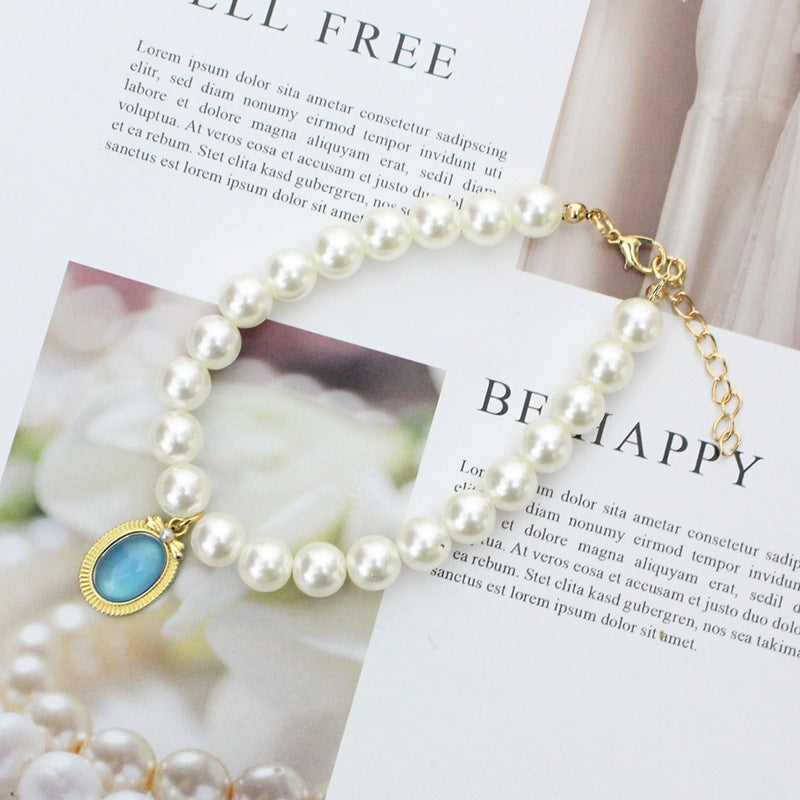 Pearl & Turquoise Pet Collar – White pearl strand with blue-green pendant, gold milgrain bezel, chic pet jewelry