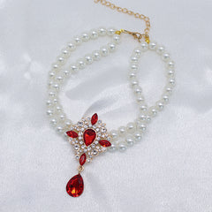 Elegant Pearl Crystal Collar – Double-layer pearl collar with red teardrop crystal surrounded by rhinestones
