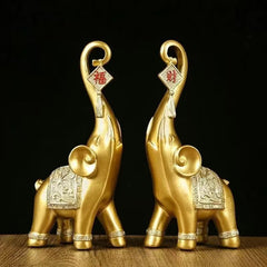 Lucky Elephant Statue – pair of golden elephants with trunks raised holding fortune charms, feng shui decor