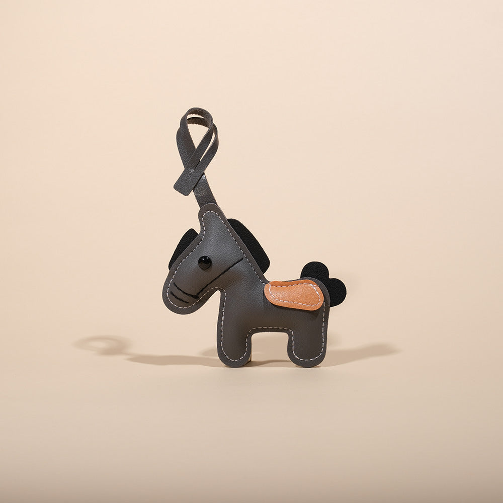 Feng Shui Leather Horse Keychain – Gray PU leather horse with black mane and tan saddle, charm gift