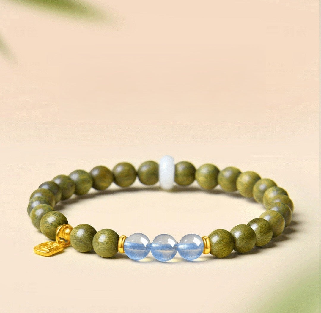 Green Sandalwood Bracelet – Single wrap with blue crystal center beads, gold spacer on beige, natural wood