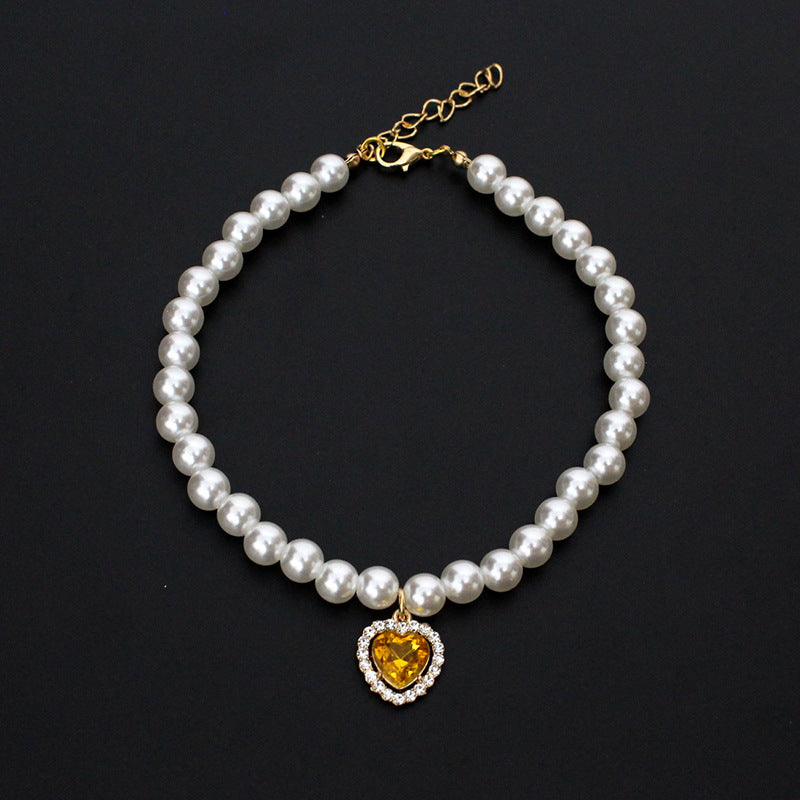 Crystal Heart Pet Necklace – Pearl collar with yellow heart crystal pendant and rhinestone border, gold clasp