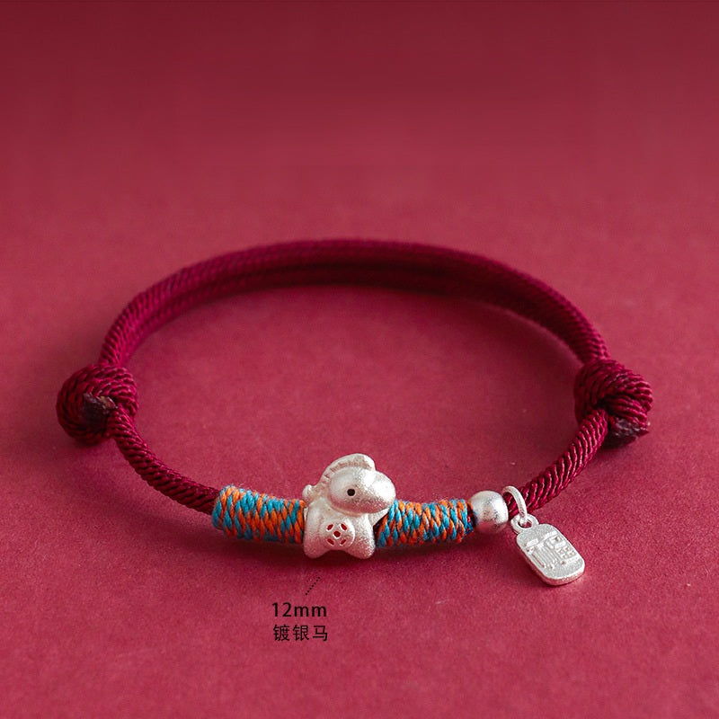 Year of the Horse Bracelet – Red cord silver horse charm with blue-orange wraps on red, feng shui