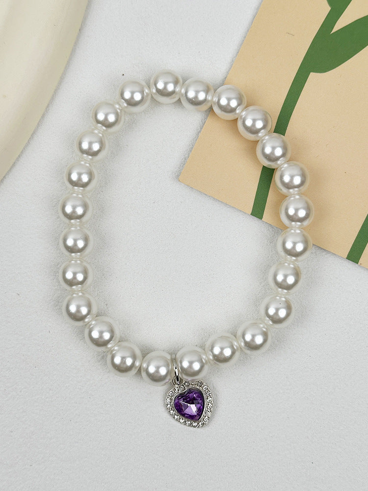 Quartz Heart Pearl Pet Collar – Pearl collar with purple crystal heart pendant on white fabric, kitten jewelry