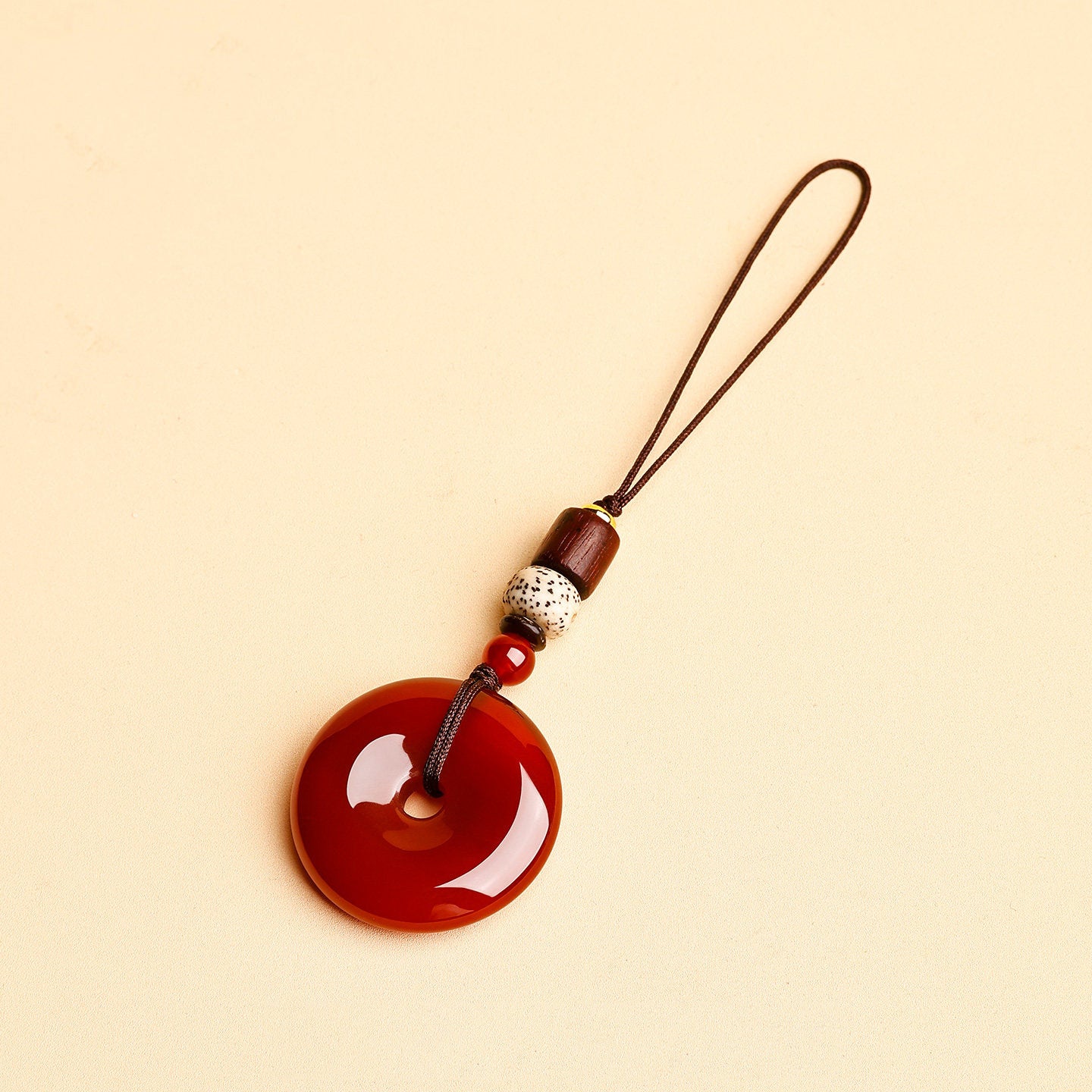 Jade Keychain Pendant – Red-brown jade donut with thin rope and wood beads on beige, car key accessory gift