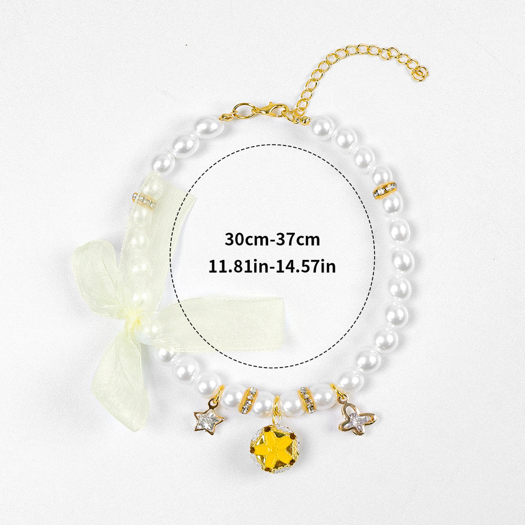 Luxury Crystal Pet Necklace – pearl strand with yellow gemstone pendant, star charms, ivory organza bow, 30-37cm