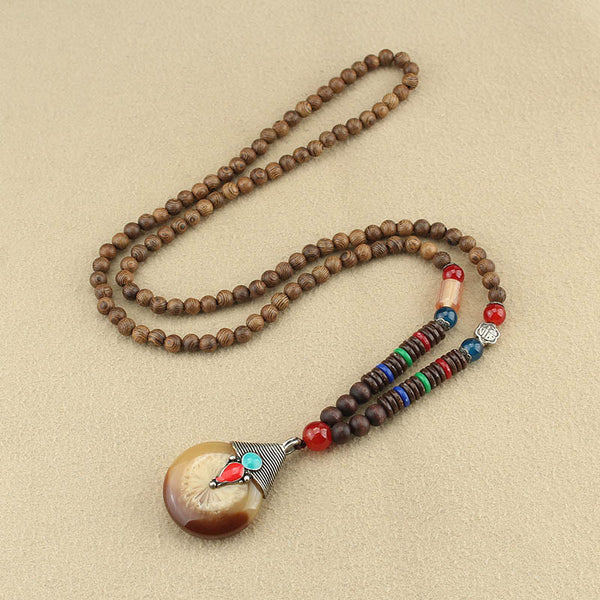 Wenge Mala Necklace – 108 beads with tan round pendant turquoise and coral accents, beige background