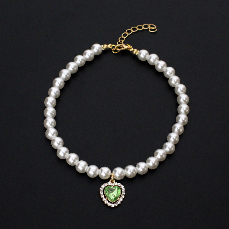 Crystal Heart Pet Necklace – Pearl collar with green heart crystal pendant surrounded by rhinestones, black