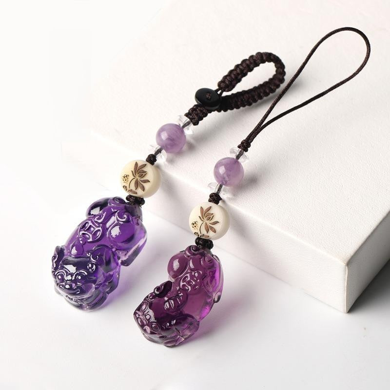 Quartz Fox Keychain – pair of purple crystal pixiu pendants with lavender beads resting against white block, healing crystal