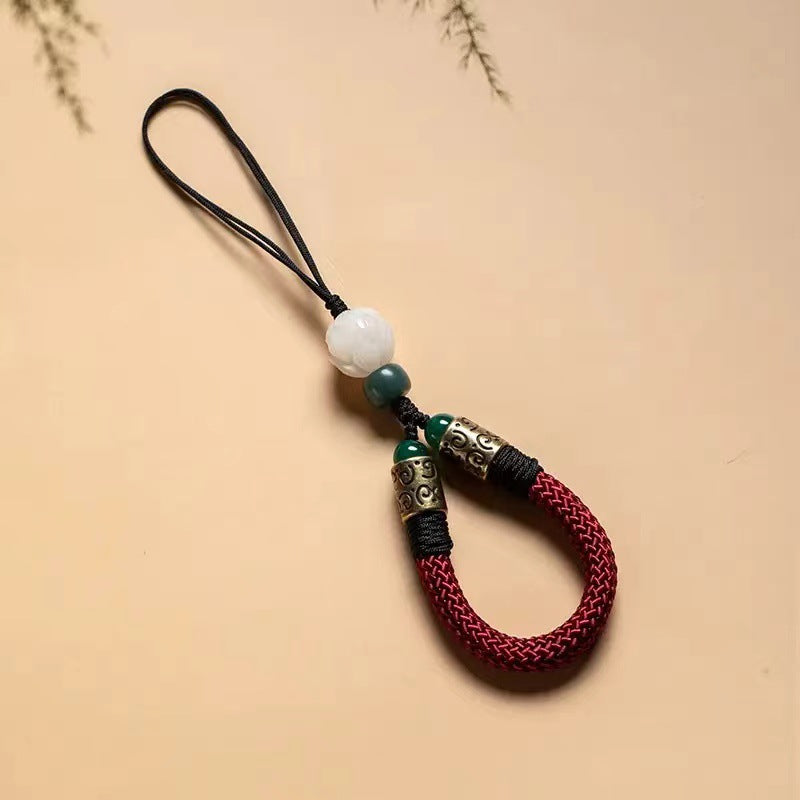 Lotus Bodhi Lanyard – Red braided wrist lanyard with white lotus bodhi bead and bronze cuffs, prosperity phone charm