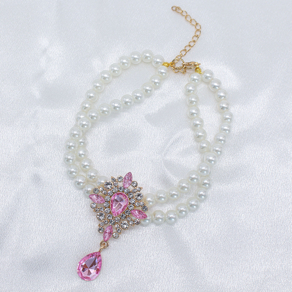 Elegant Pearl Crystal Collar – Double-layer pearl collar with pink teardrop crystal and rhinestone setting
