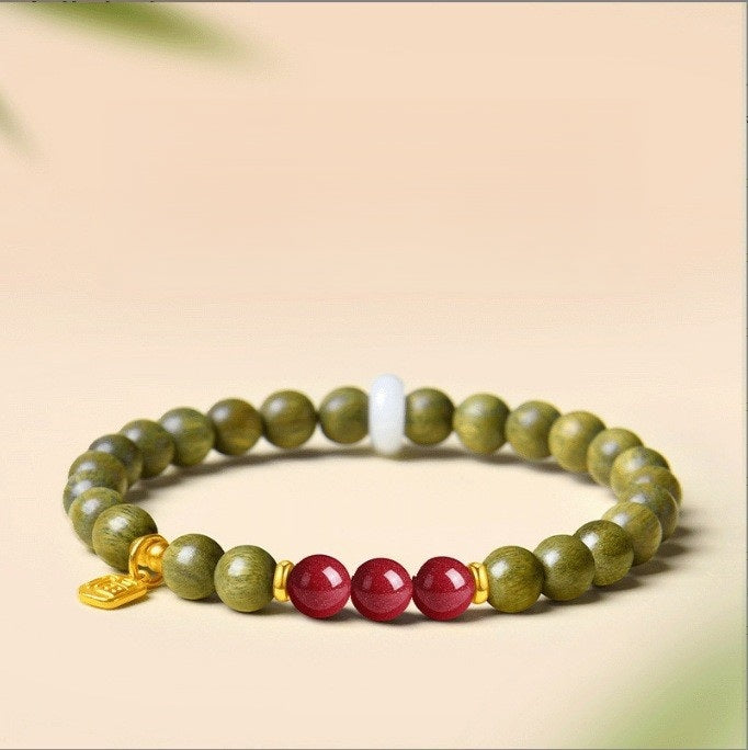 Green Sandalwood Bracelet – Single wrap with dark red garnet beads, gold spacer on beige, natural wood