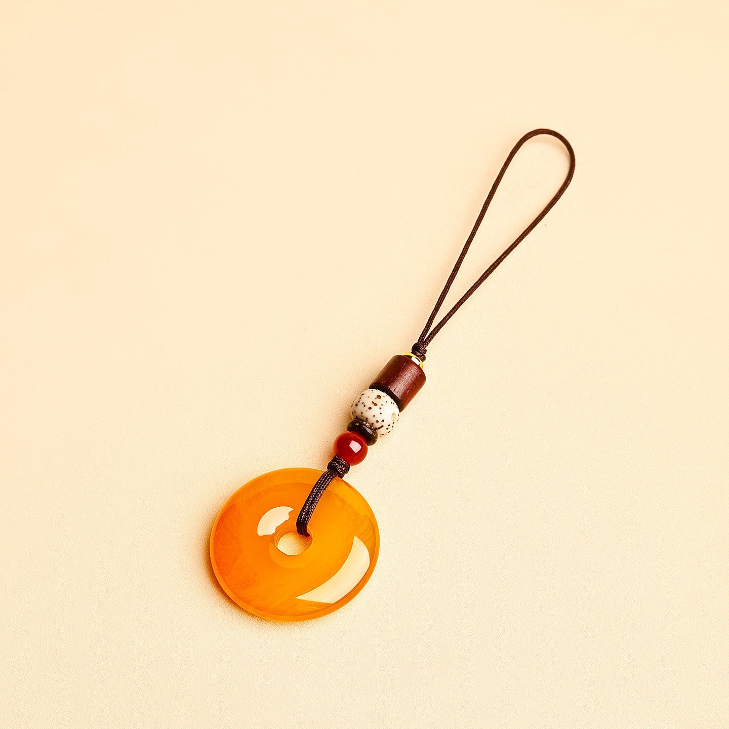 Jade Keychain Pendant – Yellow jade donut with thin cord and bodhi beads on beige background, lucky bag charm