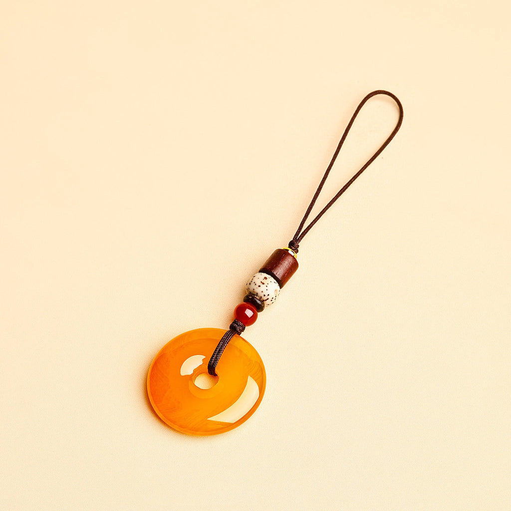 Jade Keychain Pendant – Yellow jade donut with thin cord and bodhi beads on beige background, lucky bag charm