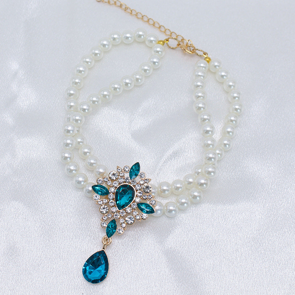Elegant Pearl Crystal Collar – Double-layer pearl collar with teal teardrop crystal and rhinestones, satin