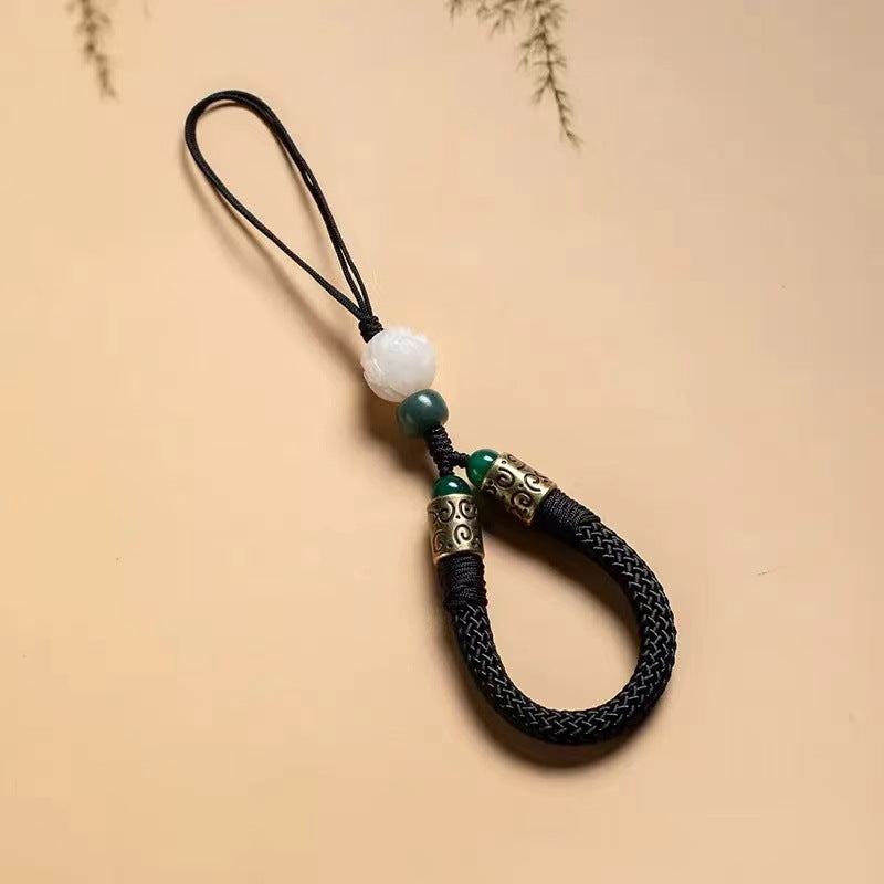 Lotus Bodhi Lanyard – Black woven phone strap with white bodhi lotus bead and jade accent, spiritual protection accessory
