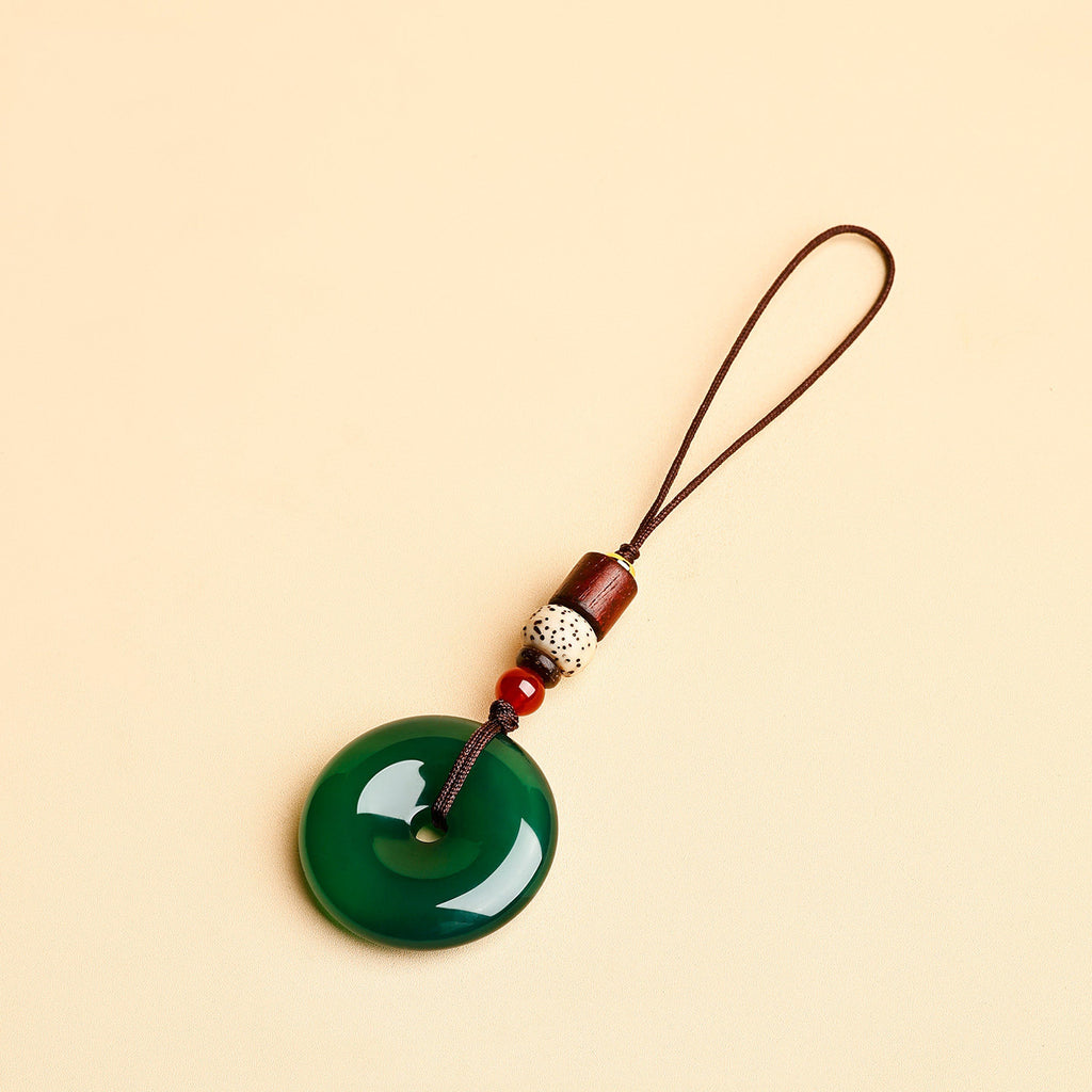 Jade Keychain Pendant – Green jade donut with slim cord and red agate beads on beige, spiritual keychain gift