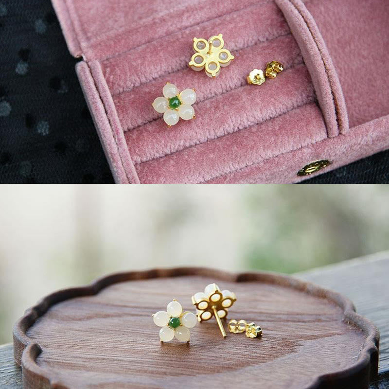 White Jade Flower Blessing Stud Earrings – Two pairs: white jade five-petal and gold four-petal clover earrings with butterfly backs, dusty rose velvet box and scalloped wooden dish