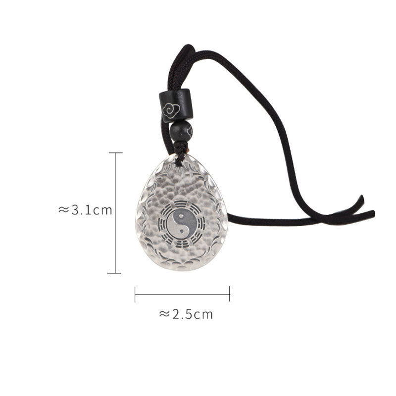 Yin Yang Bagua Water Drop Necklace – Transparent crystal teardrop pendant with engraved yin-yang bagua and cloud patterns on black cord with wooden beads, white background