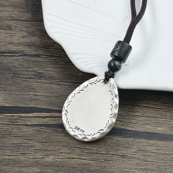 Yin Yang Bagua Water Drop Necklace – 999 fine silver teardrop pendant with engraved wave border and 999 purity stamp on dark cord with black beads, dark wood
