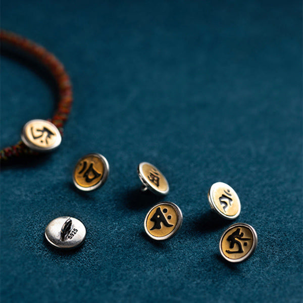 Zodiac motif charms on braided cord bracelets