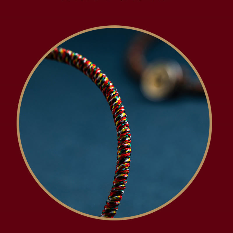 Chinese Zodiac Natal Buddha Bracelet – Tight spiral weave cord in red yellow green black white threads, circular gold frame on burgundy backdrop