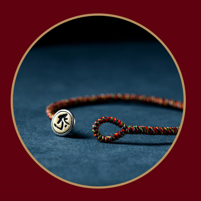 Chinese Zodiac Natal Buddha Bracelet – Braided cord with silver metal bead and black engraved zodiac symbol, circular gold frame display