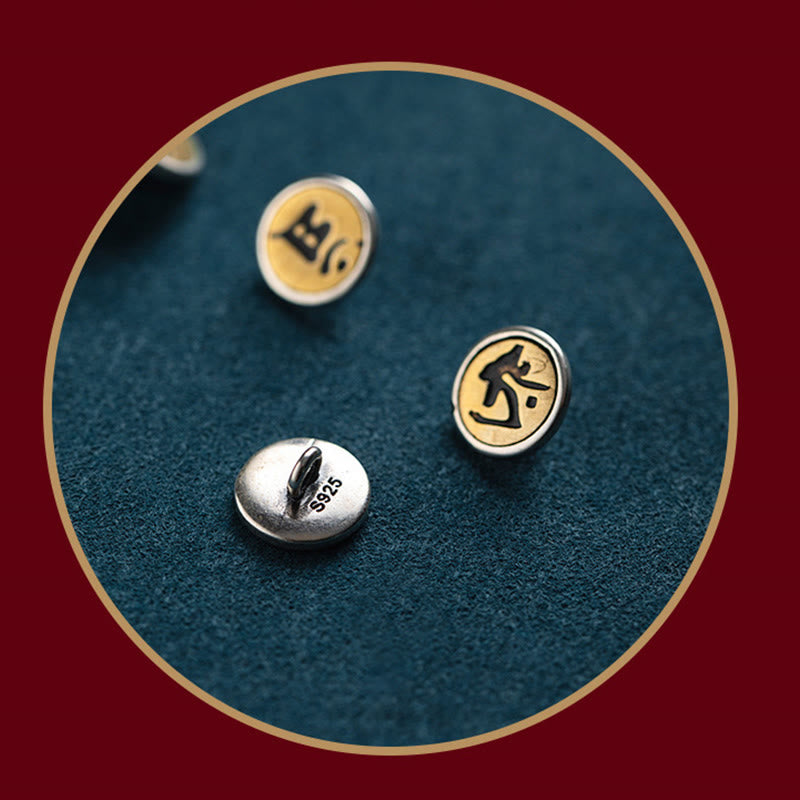 Chinese Zodiac Natal Buddha Bracelet – Three round sterling silver stud earrings with gold Sanskrit designs on S925 posts, teal fabric close-up